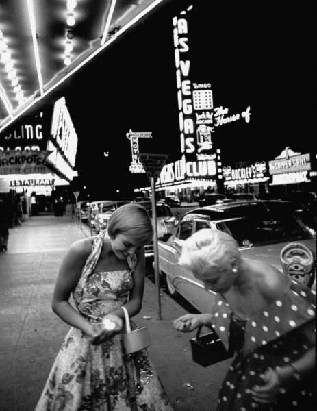 vintage image of two women in the 1950s in las vegas having fun in their 1950s fashions on the Las Vegas strip. 