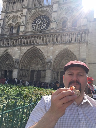 Eating French Bread in front of the Notre Dame Paris France-Vitnage Inn Blog