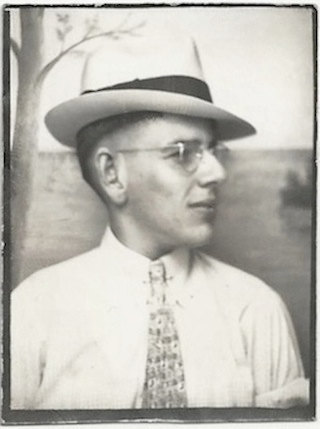 1930s photobooth vintage image of man wearing a hat and glasses. 