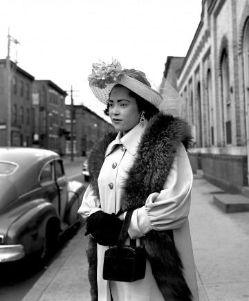 John W. Mosley - Easter Sunday, c. 1950 vintage image of a Black woman all dressed up in a stylish 1950s coat and 1950s hat with fur. 