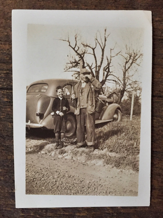 1930s vintage photo of father and son with vintage car going fishing