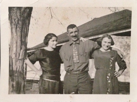 1920s vintage photo of father with his daughters.Fun 1920s fashions.