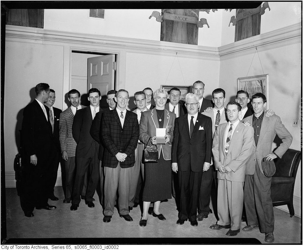 1950s vintage photo of a reception for the Canadian Olympic Team and members of the Canadian Olympic Association in the office of City of Toronto Mayor Nathan Phillips in 1956. 