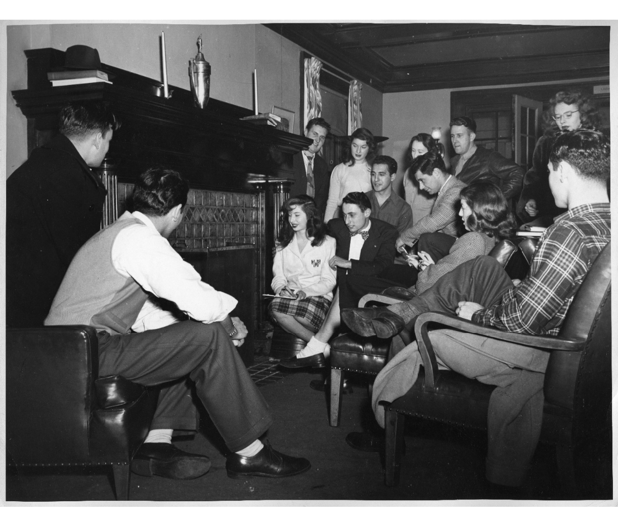 Group of university students at Wayne State University gathered around a fireplace in the 1940s. 1940s Vintage Student life Photo