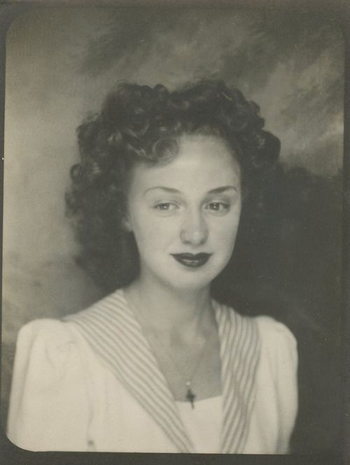 1940s Vintage Photo of a young woman in a photo booth with curly hair. Vintage Hair Inspiration from the 1940s. 