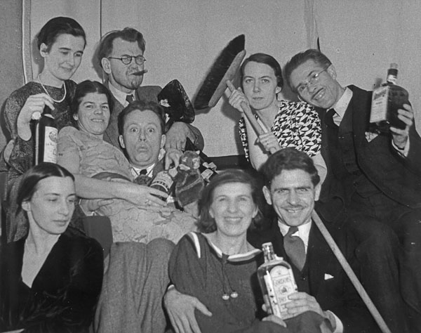 1930s vintage photo of a group of party attendees at a New Years Eve Party. They are wearing 1930s fashions and 1930s hairstyles