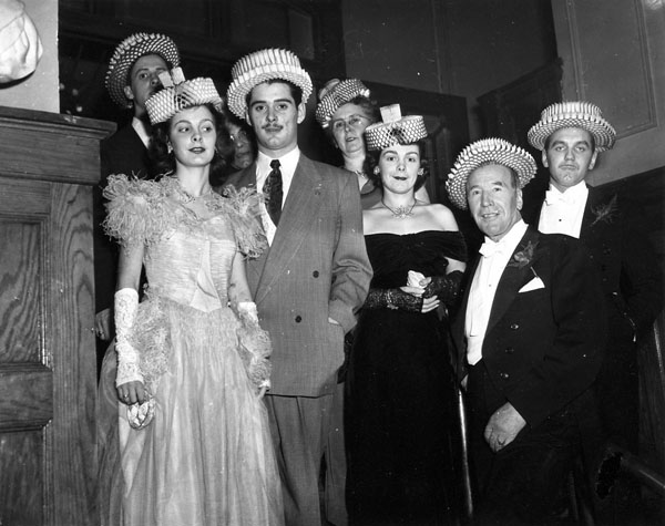 1940s Vintage Photo of  a group in 1940s fashions wearing party hats. James Patrick Maloney (owner of the Standish Hotel) and wife Columbe and guests wearing paper hats on New Year's Eve.