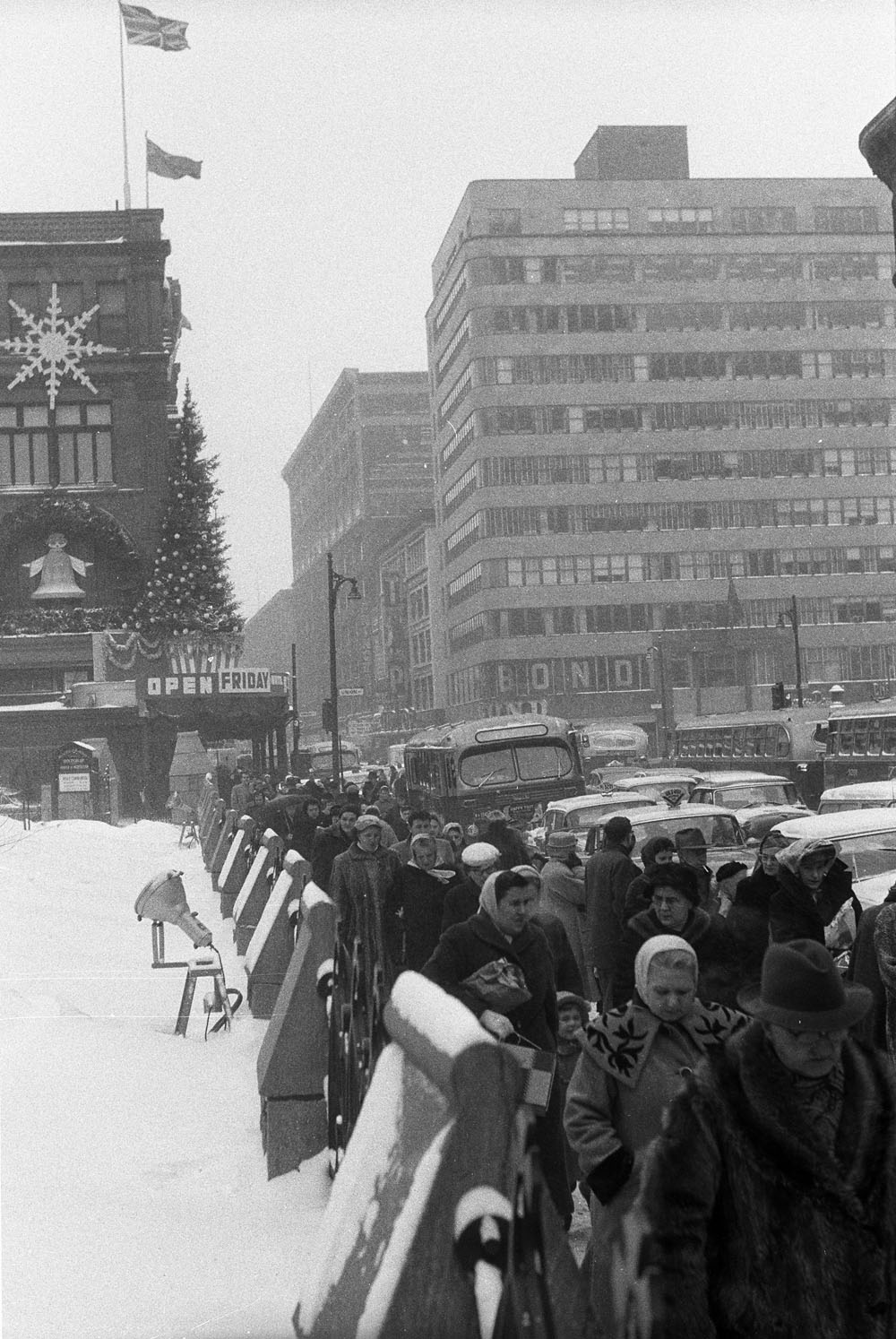 1950s vintage photo:  St. Catherine street in Montreal, Quebec filled with Christmas shoppers circa 1957.