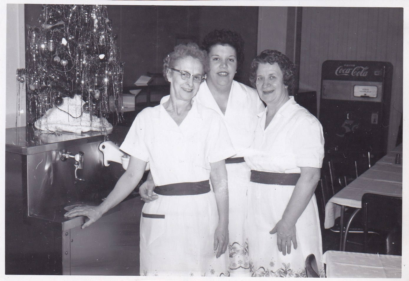 1950s vintage photo of 3 lunch ladies posing by their small Christmas Tree