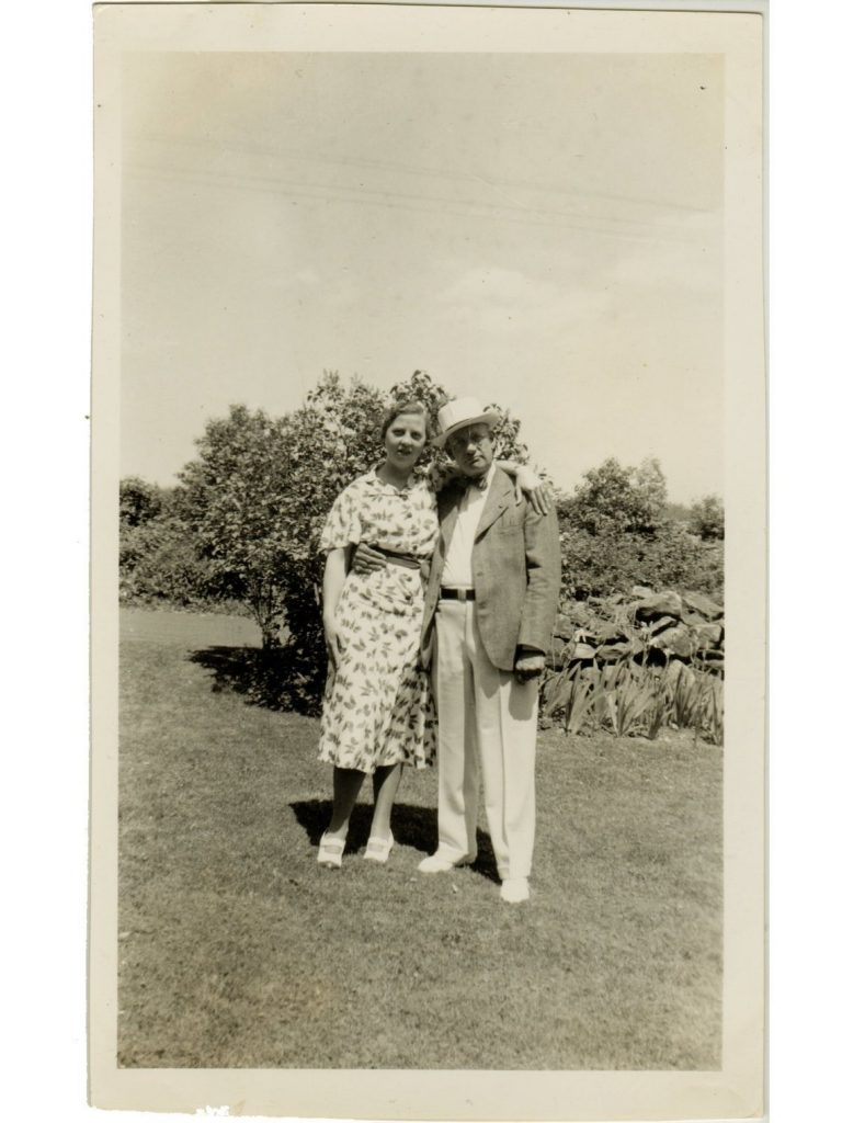 1930s vintage photo of an older couple standingin a garden