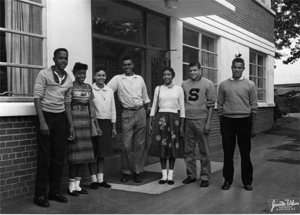 1950s Teenager fashion vintage photo featuring a group of Black Teenagers in 1950s fashion posing for a photo. 