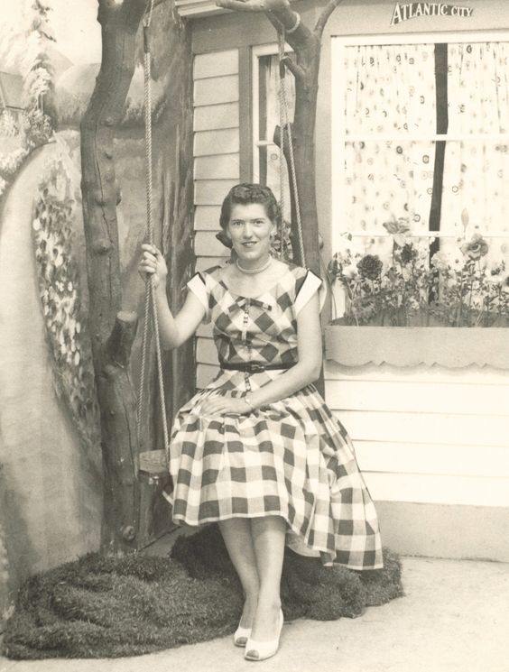 1950s Vintage Photo of a woman on a swing in a gingham dress 1950s fashion vintage vacation