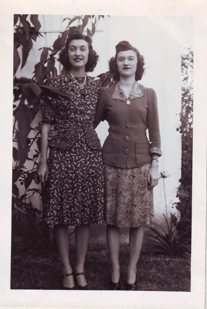 1940s vintage photo of two young womn in 1940s hairstyles and 1940s fashions. 1940s Dresses with Jackets. Lovely 1940s style. 