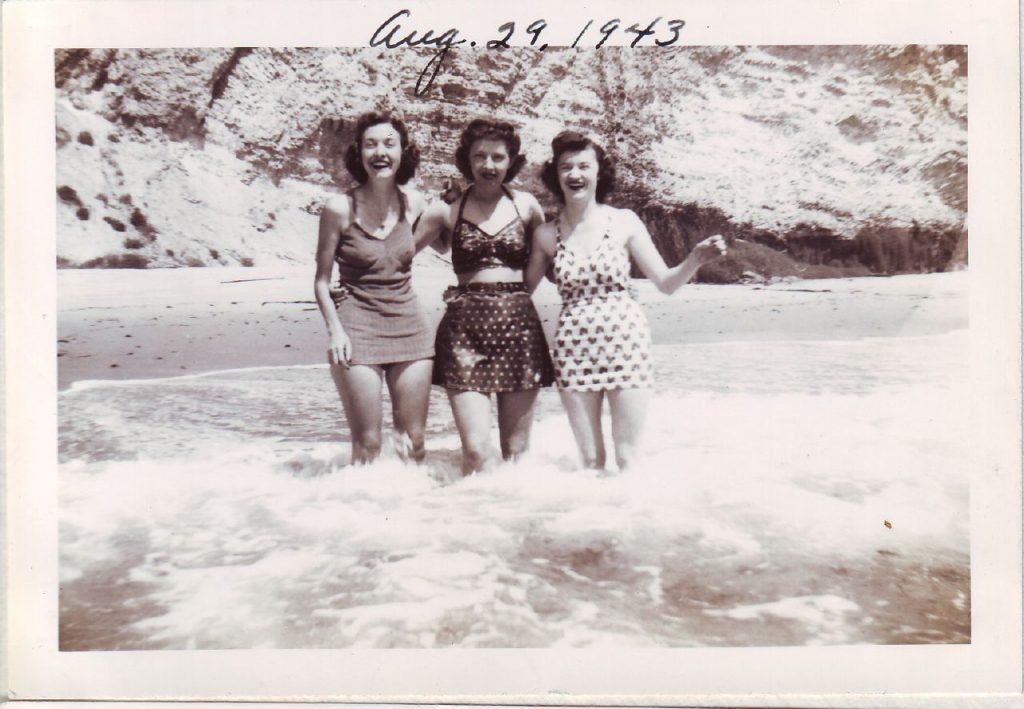 August 1943-1940s Vintage Photo of 3 young women in 1940s swimsuits / 1940s bathinsuits and 1940s hairstyles posing in the water. Great 1940s Summer Beach Fashions. 