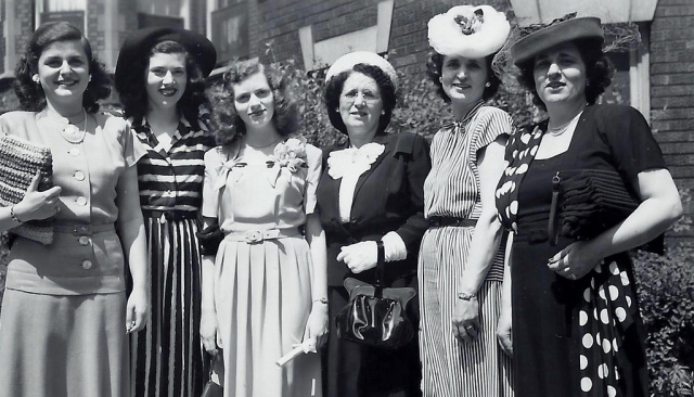 1940s vintage photo of a group of young women and their mothers in amazing 1940s dresses, 1940s accessories, 1940s Hats and 1940s hairstyles posing for a photo together.