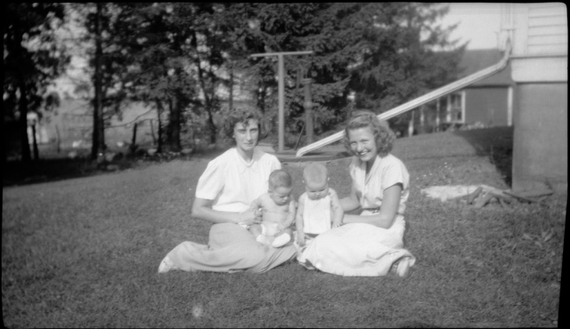 1940s vintage photo of 2 mothers on the front lawn with their kids