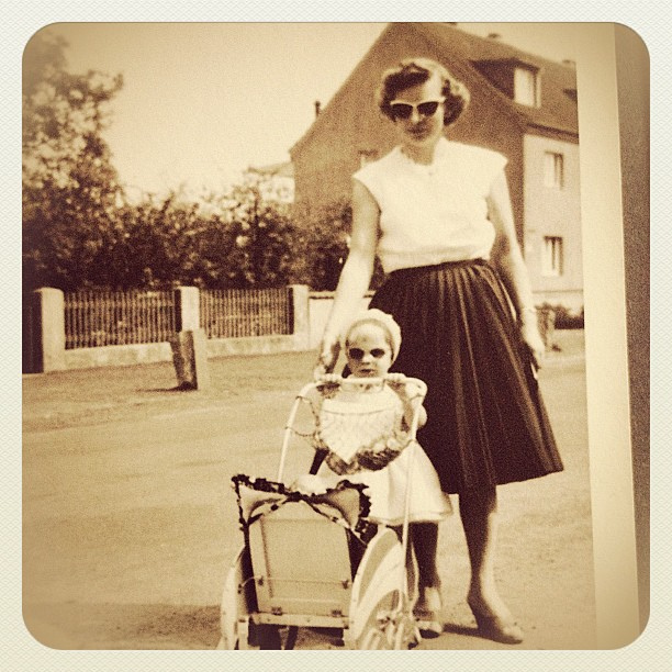 1950s mother dressed in 1950s fashion with her daughter vintage photo