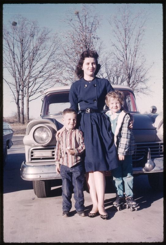 1950s photo of a 1950s mother with 2 kids in front of car vintage photo in colour happy mothers day