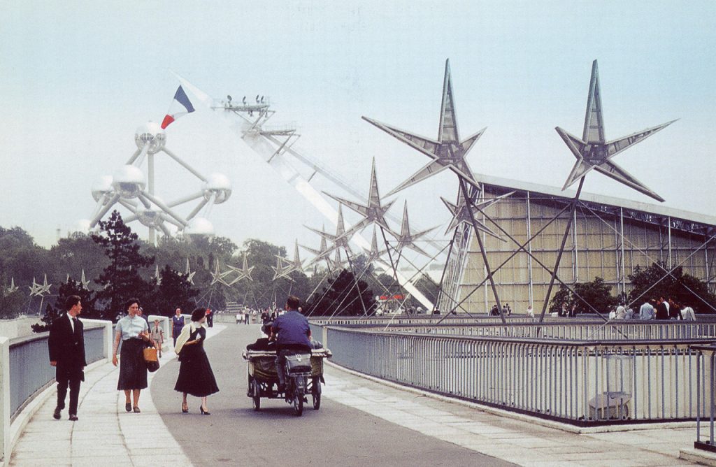 1950s Vintage Photo of the Philips Pavilion at the 1958 Brussels World's Fair in Belgium. The images also is showing people in 1950s fashions walking around. 