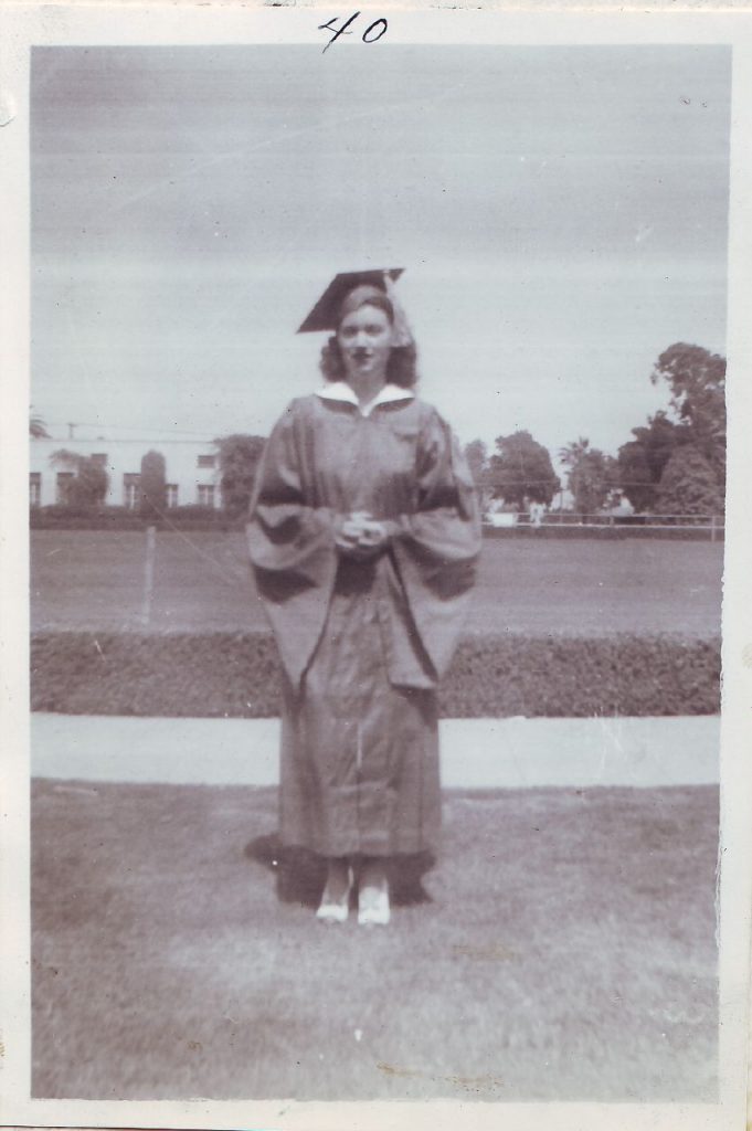 1940s Photo of a young woman graduating from highsschool-her name is betty. Betty is wearing a graduation outfit. 