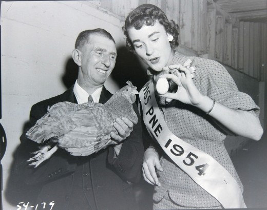 1950s Vintage phot of Miss PNE 1954 Beauty Pageant Winner holding a chicken egg. 