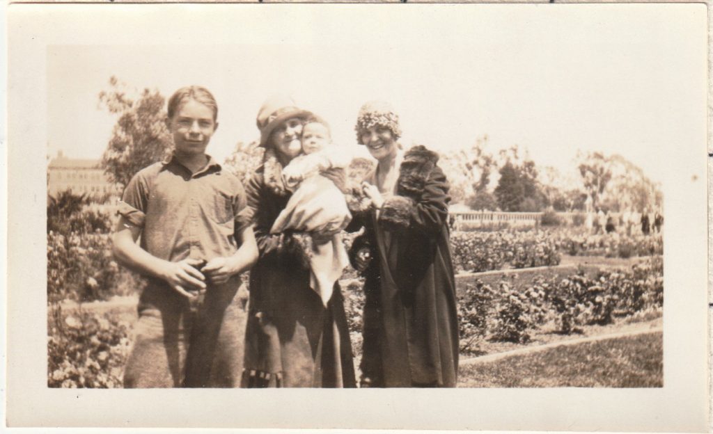 1920s photo of a family in 1920s fashion posing together with grandmother. 