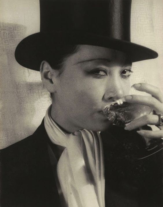 Vintage Photo of Anna May Wong - The First Asian American Movie Star in a top hat having a drink.