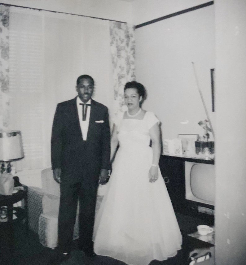 1950s photo of a well dressed black couple heading to a dance. 