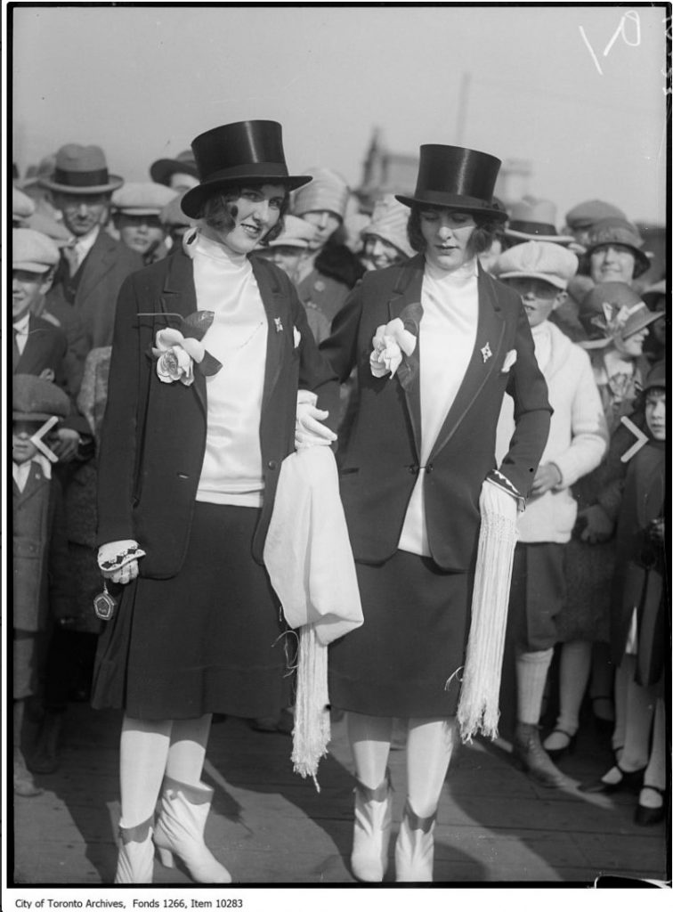 1920s photo of the Sunnyside Easter Parade in Toronto featuring two women dressed in Tuxedos 