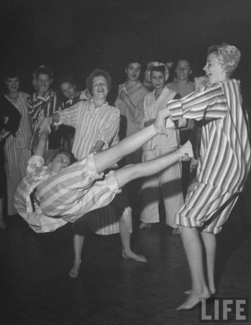 Slumber party shenanigans, 1944. 1940s photo of girls in their pajamas having fun.