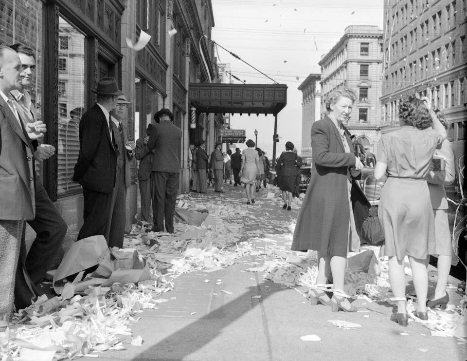 1940s vintage photo of Leftover revelry lines the streets after V.E. Day celebrations conclude.Vancover, BC 1945