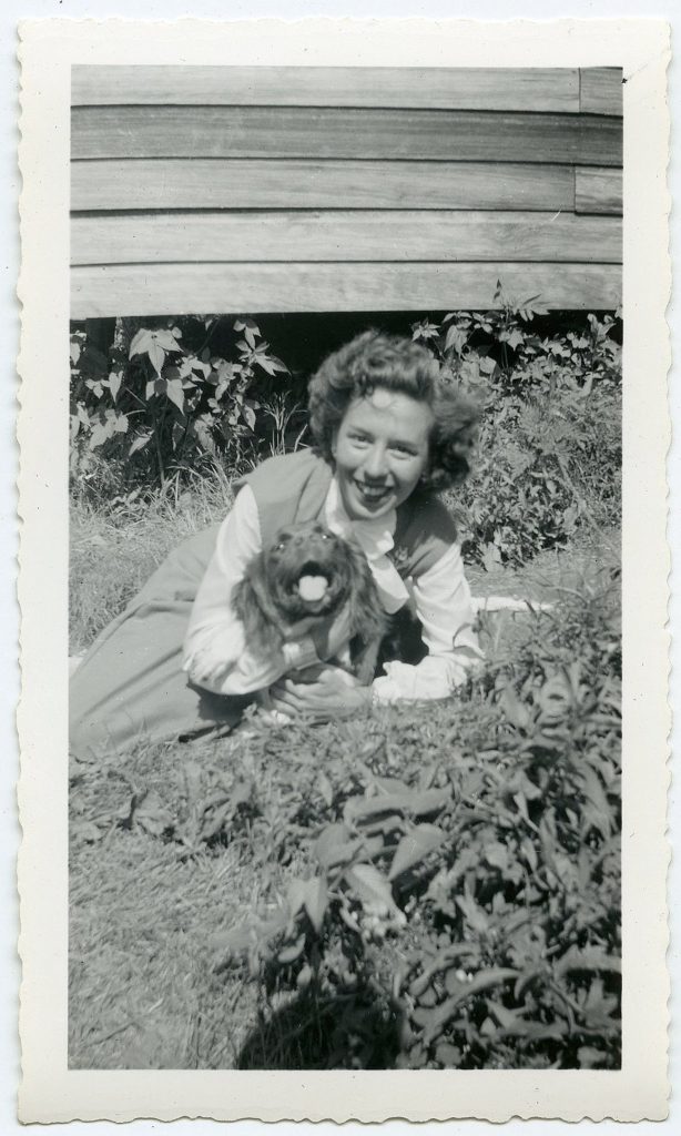 1940s Photo of a pretty woman with her dog. 