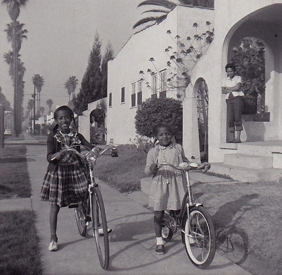 1950s Photo of 2 young Black girls riding bicycles. 