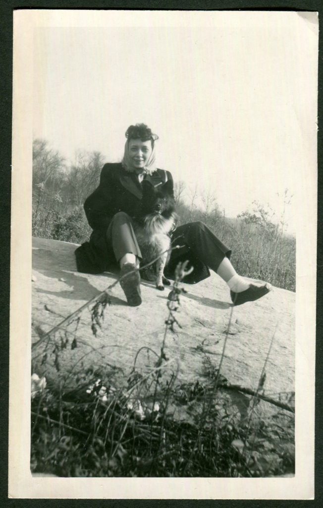 1950s Photo of a woman on a rock with her dog. Love the Vintage Hairscarf. 