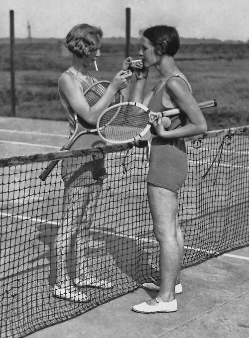 1930s Vintage Photo: 1932 Vintage Photo of 2 women smoking on the court. Both ladies are wearing what looks like 1930's swimsuits.    The perfect vintage Tennis Outfit Inspiration