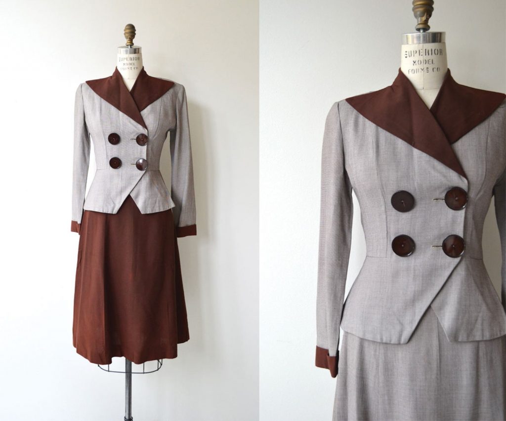 1940s lightweight gabardine wool suit with not one but two skirts! Jacket shows off oversized contrast collar, oversized double breasted buttons and feminine fitted shape.