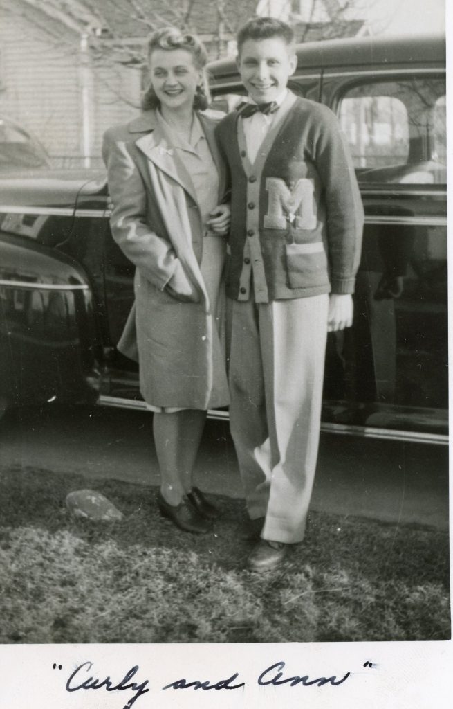 Curly Wears His Letterman Cardigan Sweater With an M Patch and Bowtie to Impress Ann in Front of a 1940s Four Door Sedan. 1940s Vintage Photo