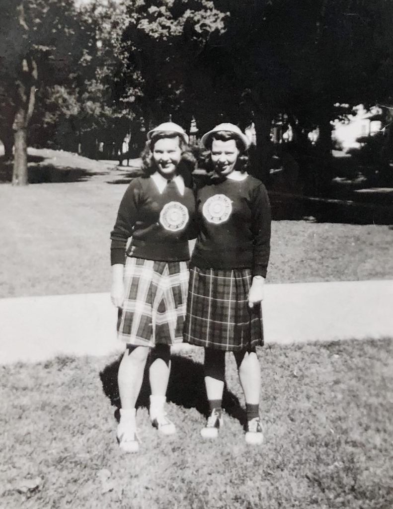 1940s Fashion: School Spirit! Plaid pleated skirts, sweaters, matching hats and saddle shoes on these two young women in this 1940s photo. 