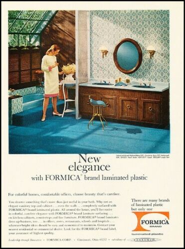 1960s vintage ad from 1966 featuring a formica bathroom counter top and carpet in the bathroom in blue colour. The woman is wearing a 1960s dress. 