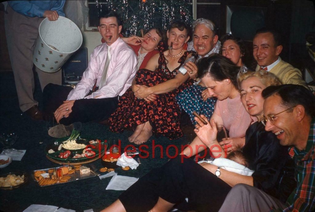 New Christmas Party game idea! Draw dark eyebrows on the men and women and smoke cigars! A 1950s vintage photo. 