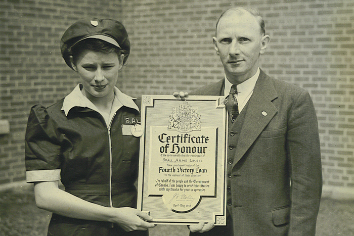 Vintage Photo: 1940s photo of a woman in factory uniform in Mississauga, Canada who worked at the Sam Arms Building during WW2