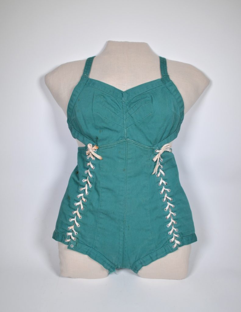 Lacing up both sides was typical of her earliest swimsuits and a 1938 example is preserved at the New Westminster Museum and Archives in Canada