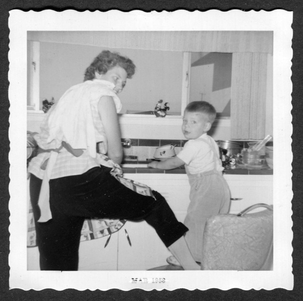 Fun in the kitchen with mom-1950s vintage photo of a litle boy with his mom possibly washing hands (maybe helping with dishes). 