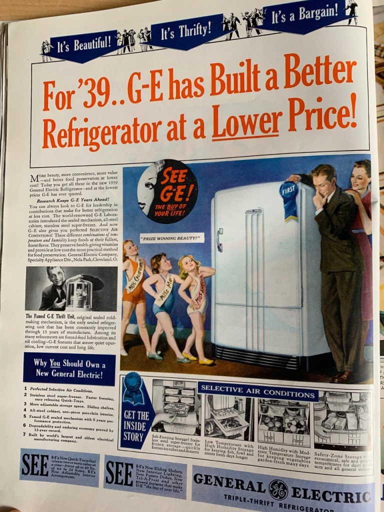 1930s Vintage ad for General Electric Refigerator featuring an illustration of a man choosing a fridge and giving it first prize. 