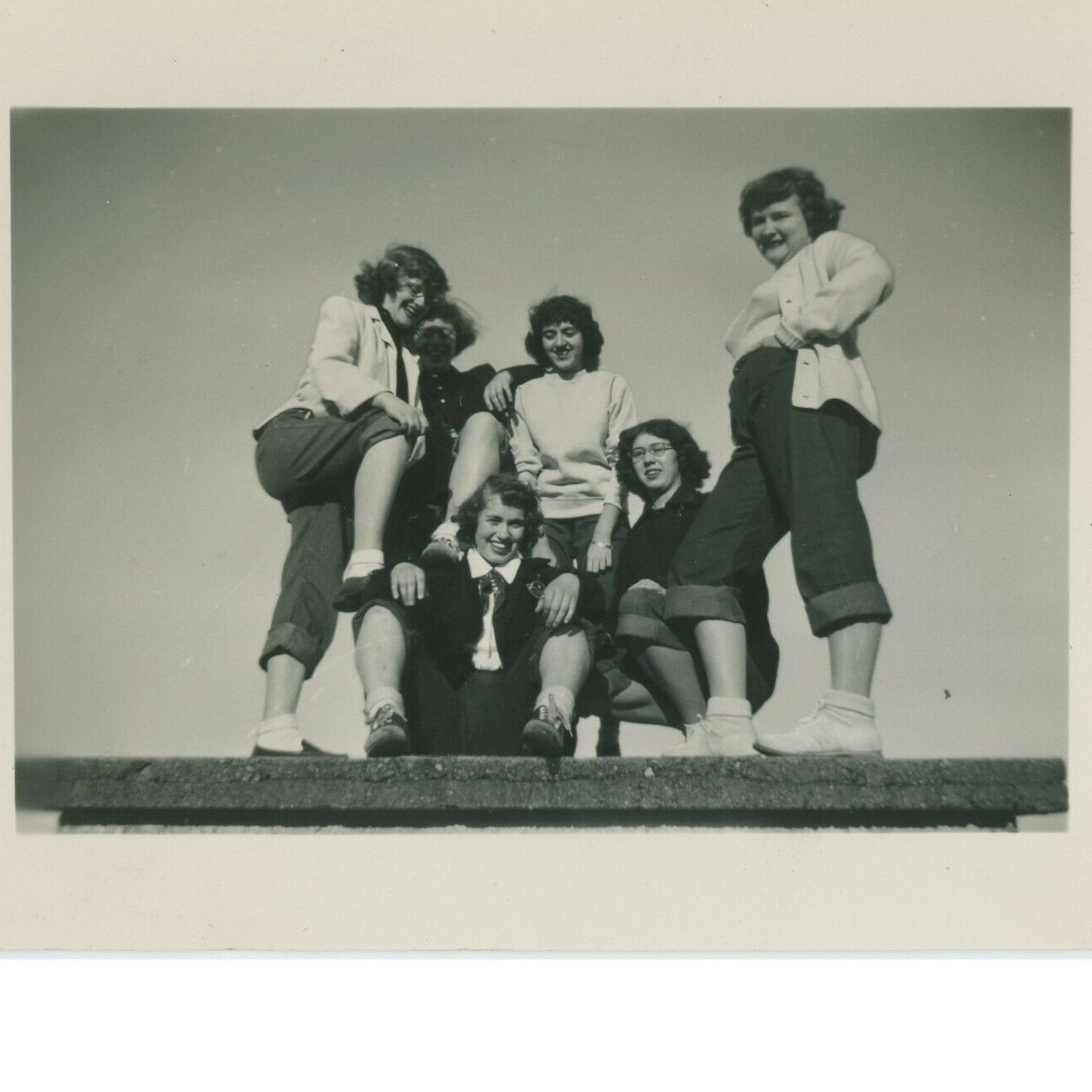 1940s photo of a group of teenagers young girls in rolled up jeans having fun together