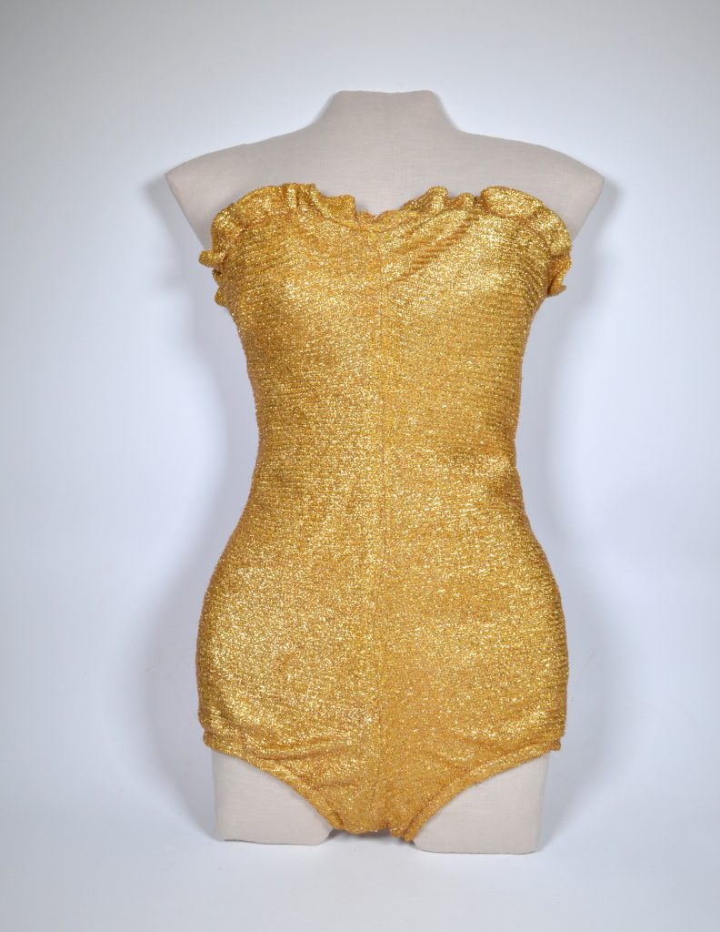 This photo shows a "Glittering Metallic Lamé" Rose Marie Reid swimsuit from 1946 owned by the Harold B. Lee Library of Brigham Young University displayed on a dressform.