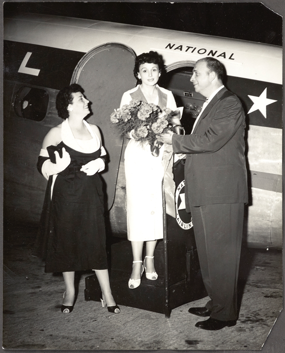 Rose Marie Reid Famous Swimsuit Designer in 1950s Clothes is met by an airplane