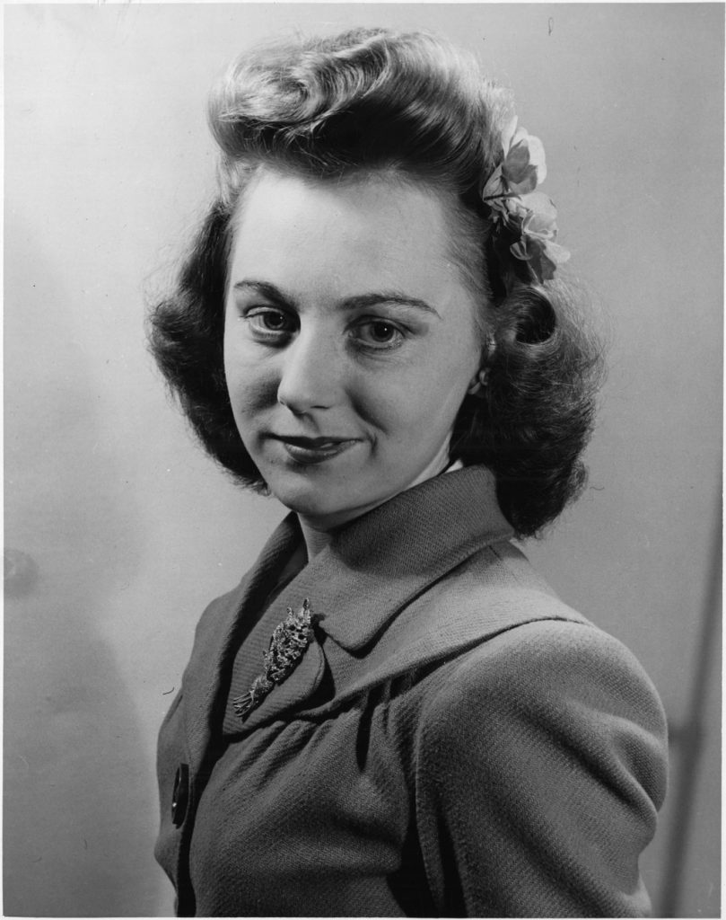 1940s Hairstyles as seen on a headshot of a woman factory worker at GECO