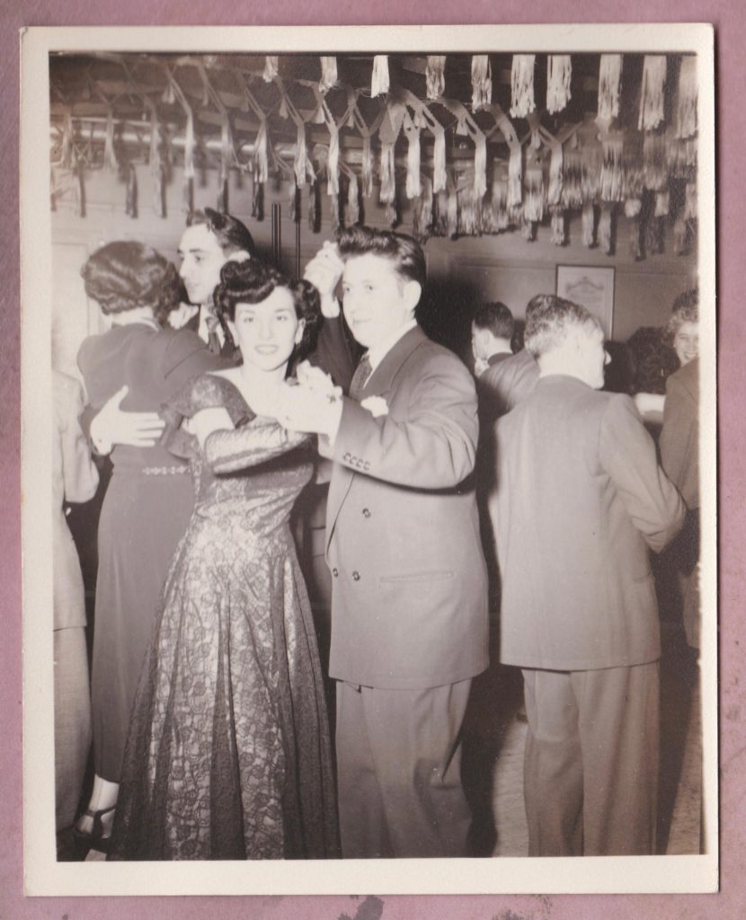 1940s vintage photo of couples dancing at a party in 1940s fashions and 1940s vintage hairstyles