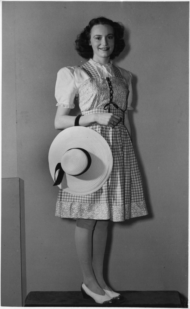 1940s Vintage Photo of a young woman from GECO Munitions factory in 1940s fashion. 